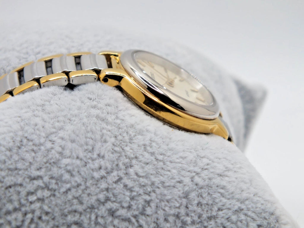 Seiko Avenue 1F21-0H50 ladies’ quartz two-tone watch with gold accents, silver band, and new battery on white fabric.