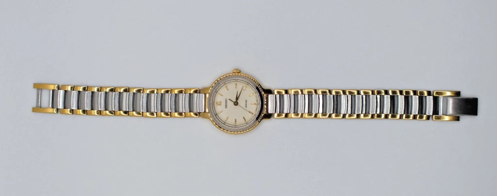 Seiko Avenue 1F21-0H50 ladies’ quartz two-tone watch with gold band, silver dial, and black hour markers.