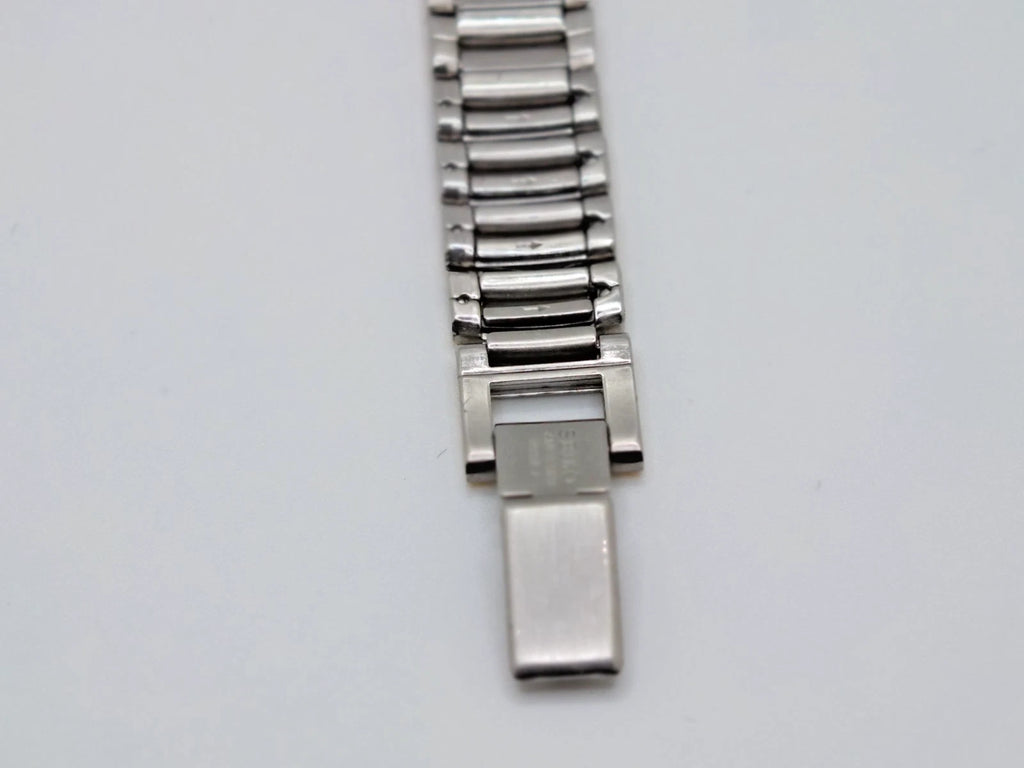 Silver and sapphire Seiko Avenue 1F21-0H50 ladies’ quartz two-tone watch with rectangular clasp and screw accents.
