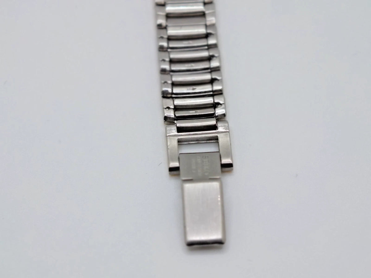 Silver and sapphire Seiko Avenue 1F21-0H50 ladies’ quartz two-tone watch with rectangular clasp and screw accents.