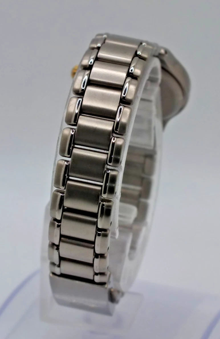 Silver titanium Citizen Exceed A930 watch with near mint dial, displayed on clear stand against plain background.