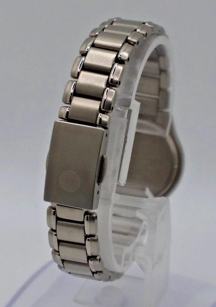 Silver titanium Citizen Exceed A930 watch with near mint dial, black hour markers, and stainless steel bracelet.