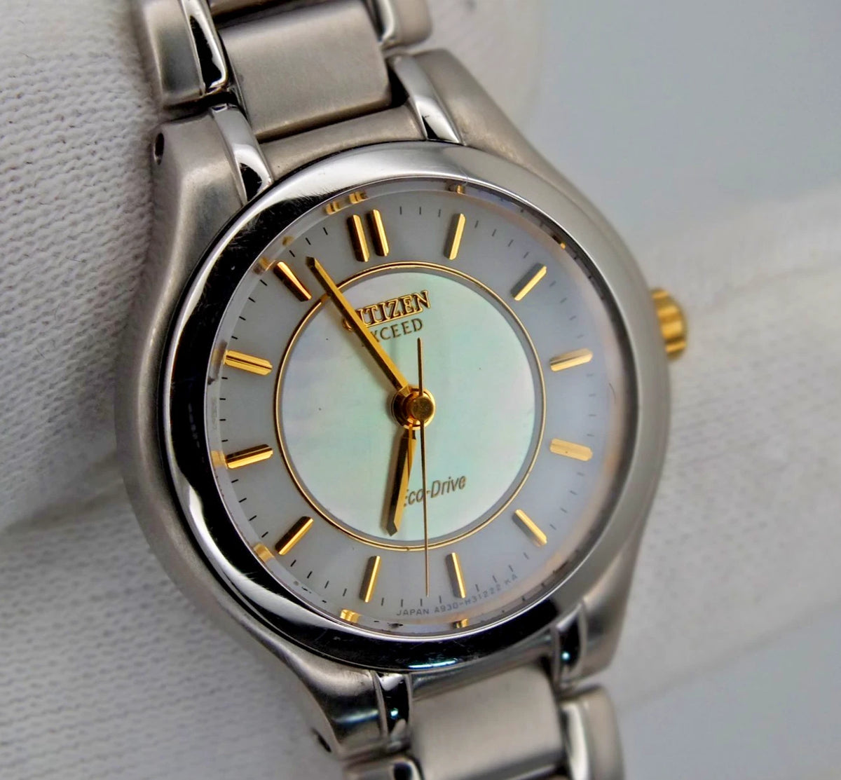Citizen Exceed A930 Eco-Drive women’s titanium watch with pearl dial, gold hour markers, and Japan-made movement.