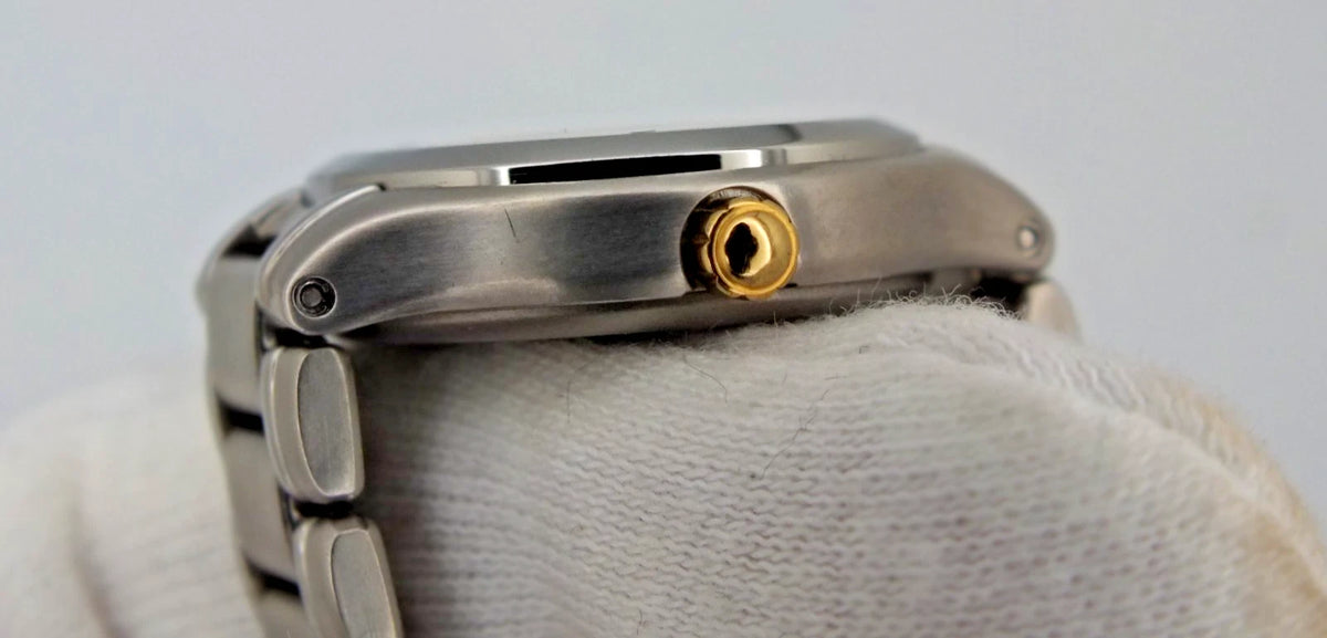 Silver titanium Citizen Exceed A930 watch with gold near-mint dial, black hour markers, and linked metal band.